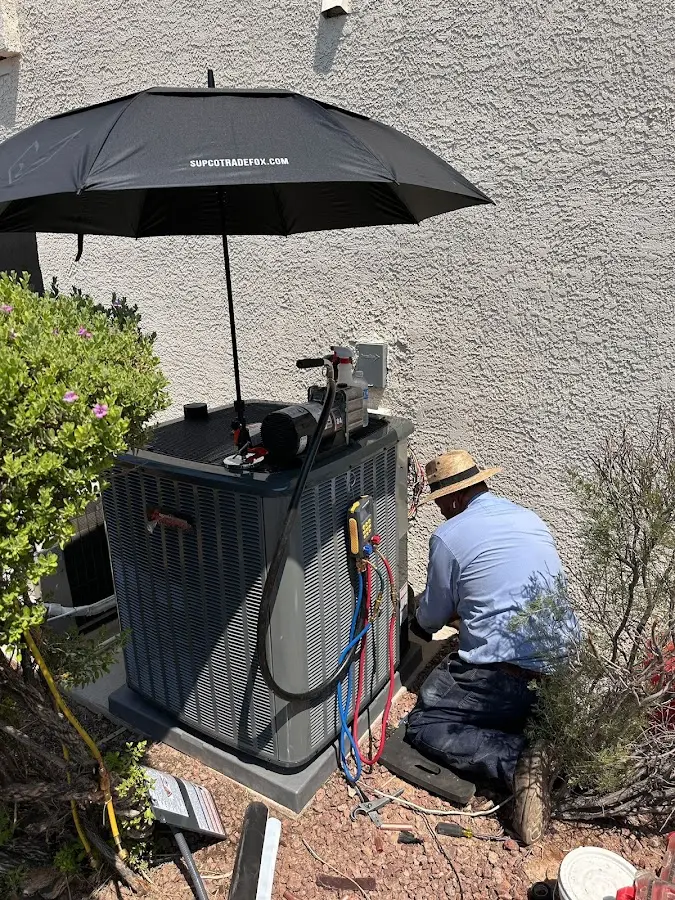 HVAC technician performing outdoor AC maintenance in Delanco